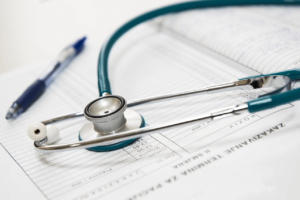 Image of a stethoscope on top of some medical files